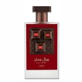 Lattafa Pride Sapphire Royal — Clear glass perfume bottle with a red label featuring a textured brown square with three inset red gems and gold accents. The cap is ribbed and bronze-colored.