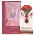 Maison Alhambra La Charmante Eclatant — Perfume bottle with ornate peacock-inspired gold and pink cap, displayed next to its matching pink and gold patterned box.