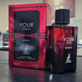 Maison Alhambra Your Touch Extrait — Red box and dark red glass bottle of Your Touch Extrait by Maison Alhambra 100ml Extrait de Parfum, with deer logo.