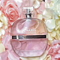 Maison Alhambra Chants Tenderina by Maison Alhambra 100ml EDP — A pink glass perfume bottle with a clear faceted cap, labeled 'CHANTS EAU DE PARFUM TENDERINA', rests on a bed of soft pink and cream fabric roses.