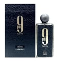 Afnan 9 PM Night Out Extrait de Parfum — A dark textured box stands next to a clear glass perfume bottle with a textured dark label and a grey spherical cap. | Afnan 9 PM Night Out Extrait de Parfum — Kotak bertekstur gelap berdiri di sebelah botol minyak wangi kaca jernih dengan label gelap bertekstur dan penutup