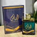Ard Al Zaafaran Al Qannas Eau De Parfum 100ml — A dark blue box with gold Arabic calligraphy and wavy lines sits next to a square, dark green glass perfume bottle with a gold cap. | Ard Al Zaafaran Al Qannas Eau De Parfum 100ml — Kotak biru gelap dengan kaligrafi Arab emas dan garisan berombak terletak di sebelah