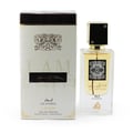 Lattafa Ana Abiyedh Leather 60ml by Lattafa Perfumes — A white perfume box with gold accents and Arabic calligraphy sits next to a clear glass perfume bottle with a gold cap and black accents, also featuring Arabic calligraphy. | Lattafa Ana Abiyedh Leather 60ml oleh Lattafa Perfumes — Kotak minyak wangi putih dengan