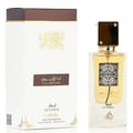 Lattafa Ana Abiyedh Leather 60ml by Lattafa Perfumes — A white perfume box with gold Arabic calligraphy and a clear glass bottle with gold accents and a dark cap, displayed side-by-side. | Lattafa Ana Abiyedh Leather 60ml by Lattafa Perfumes — Kotak minyak wangi putih dengan kaligrafi Arab emas dan botol kaca jernih