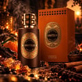 French Avenue Anatolia Absolus Les Extraits Unisex — Botol minyak wangi coklat gelap berlabel emas, sebelah kotak orennya. Dikelilingi kristal ambar, kayu manis, lada hitam, dengan asap naik.
