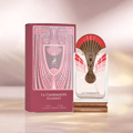 Maison Alhambra La Charmante Eclatant — Pink art deco box and ornate gold and red peacock-feathered perfume bottle with gold base
