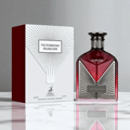 Maison Alhambra Victorioso Fearless 100ml EDP — A red glass perfume bottle with a silver geometric design and black cap, placed next to its white and red patterned box on a reflective surface.