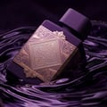 Lattafa Bade'e Al Oud Amethyst Fusion 100ml — A purple perfume bottle with a gold ornate label, submerged in swirling dark purple liquid.
