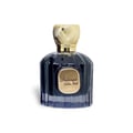 Maison Alhambra Baroque Satin Oud 100ml — Dark blue glass perfume bottle with a textured gold cap and a gold oval label that reads "Baroque Satin Oud". | Maison Alhambra Baroque Satin Oud 100ml — Botol minyak wangi kaca biru gelap dengan penutup emas bertekstur dan label bujur emas bertulis "Baroque Satin Oud".