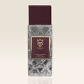 Bujairami Billion Dollar by Bujairami 100ml Extrait — Clear faceted glass perfume bottle with a deep red cap and a gold-trimmed maroon label featuring a 'B' logo and text.