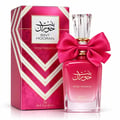 Ard Al Zaafaran Bint Hooran Rose Passion — Pink perfume bottle with a large pink bow, crystal cap, and gold accents, next to its matching pink and gold chevron patterned box.