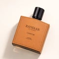 Rayhaan Corium by Rayhaan 100ml EDP — Botol minyak wangi berbentuk segi empat dengan balutan tekstur kulit perang dan jahitan di tepi, tertulis teks hitam dan penutup hitam.