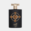 Lattafa Pride Al Qiam Gold — Black perfume bottle with gold accents and a circular emblem featuring amber-colored stones.