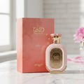 Zimaya Daiman Eden Eau De Parfum 100ml by Zimaya — A pink marble box and a pink and gold perfume bottle are displayed on a marble surface with a blurred pink flower in the background. | Zimaya Daiman Eden Eau De Parfum 100ml by Zimaya — Peti marmar merah jambu dan botol minyak wangi merah jambu dan emas dipamerkan di