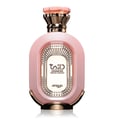 Zimaya Daiman Eden Eau De Parfum 100ml by Zimaya — A pink oval perfume bottle with a textured surface, gold accents, and a faceted pink and gold cap, set against a white background with a subtle reflection. | Zimaya Daiman Eden Eau De Parfum 100ml by Zimaya — Botol minyak wangi bujur merah jambu dengan permukaan