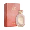 Zimaya Daiman Eden Eau De Parfum — A pink and gold patterned box stands next to a light pink oval perfume bottle with a gold cap and ornate gold detailing on the front. | Zimaya Daiman Eden Eau De Parfum — Sebuah kotak bermotif merah jambu dan emas berdiri di sebelah botol minyak wangi bujur berwarna merah jambu muda