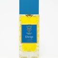Bujairami Drip by Bujairami 100ml Extrait — Yellow liquid in a clear, diamond-patterned glass bottle with a blue cap and gold accents on the label.