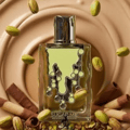 Maison Alhambra Sugar Me Pistachio Chocolate by Maison Alhambra 100ml EDP — A clear glass perfume bottle with a green, dripping design and silver cap, surrounded by pistachios and chocolate wafer rolls against a swirled caramel background.