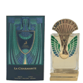 Maison Alhambra La Charmante by Maison Alhambra 100ml EDP — A perfume bottle with a gold peacock-inspired cap and green/blue feather details, displayed next to its matching dark green box with art deco design and a deer emblem.