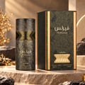 Lattafa Fearless by Lattafa 100ml EDP Men — A textured dark bottle with gold accents and Arabic script, next to its matching dark textured box with gold trim, set on a stone surface with blurred golden foliage.