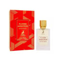 Maison Alhambra Flower Addiction Edition Rouge 100ml — A red geometric patterned box stands next to a clear glass perfume bottle with a gold cap and a white label. | Maison Alhambra Flower Addiction Edition Rouge 100ml — Kotak bermotif geometri merah berdiri di sebelah botol minyak wangi kaca jernih dengan penutup