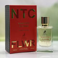 Maison Alhambra Flower Addiction Edition Rouge 100ml — Red box with gold lettering "NTC" and "FLWR" next to a clear glass perfume bottle with a gold cap and deer logo. | Maison Alhambra Flower Addiction Edition Rouge 100ml — Kotak merah dengan tulisan emas "NTC" dan "FLWR" di sebelah botol minyak wangi kaca jernih