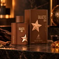 Maison Alhambra Galactic Men Intense — Brown perfume bottle and box with gold star accents, set on a marble surface with spices and wood.
