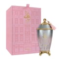 Zimaya Ghali Elegant Eau De Parfum 100ml by Zimaya — A pink box with a building facade pattern and gold Arabic calligraphy sits next to a fluted glass perfume bottle with a gold base and a pink tassel on the cap. | Zimaya Ghali Elegant Eau De Parfum 100ml oleh Zimaya — Peti merah jambu dengan corak fasad bangunan dan