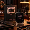 RASASI Hawas Black For Him by Rasasi 100ml EDP — Botol dan kotak wangian hitam dengan corak ular, di atas meja bersama buku nota kulit, pen, dan glob.