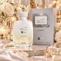 RASASI Hawas Blanche by Rasasi 100ml EDP — White perfume bottle with rope-like cap and silver box, surrounded by white roses and lit candles on a marble tray.