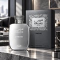 RASASI Hawas Chrome For Him — Silver perfume bottle and grey textured box with snake print detail, displayed on a marble surface with a blurred modern interior background.