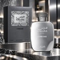 RASASI Hawas Chrome For Him by Rasasi 100ml EDP — Silver chrome perfume bottle and matching box with snake-skin texture detail, displayed on a reflective metallic surface with dark rocks.