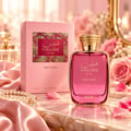 RASASI Hawas Dreams by Rasasi 100ml EDP — Pink perfume bottle and box with gold accents, surrounded by pink roses and silk fabric on a marble surface.
