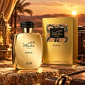 RASASI Hawas Exotic by Rasasi 100ml EDP — Gold perfume bottle and box displayed on textured rocks with a desert sunset background, palm trees, and ornate lanterns.