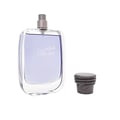 Rasasi Hawas For Him Eau De Parfum 100ml by Rasasi — A clear glass perfume bottle with purple liquid and a grey spray nozzle, next to its dark, textured cap with a snake design. | Rasasi Hawas For Him Eau De Parfum 100ml by Rasasi — Botol minyak wangi kaca jernih dengan cecair ungu dan muncung semburan kelabu