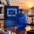 RASASI Hawas Gold Digger by Rasasi 100ml EDP — Botol dan kotak minyak wangi biru di atas dek kapal layar waktu matahari terbenam, dengan pantulan lautan keemasan.