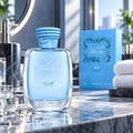 RASASI Hawas Ice Freeze by Rasasi 100ml EDP — Botol kaca biru berisi cecair biru muda, penutup biru bertekstur, di atas permukaan marmar bersama ketulan ais dan titisan air. Kotak dan tuala di latar belakang.