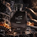 RASASI Hawas Kobra by Rasasi 100ml EDP — Black glass bottle with textured snake-like cap, set on dark rocks with amber crystals and peppercorns, wisps of smoke rising.