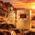 RASASI Hawas Lava Gold by Rasasi 100ml EDP — Golden cracked bottle and box set on rocky terrain with a sunset desert background.
