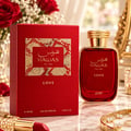 RASASI Hawas Love For Her by Rasasi 100ml EDP — Red perfume bottle with gold cap next to its matching red box, surrounded by red roses and gold jewelry on a marble surface.