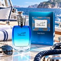 RASASI Hawas Nautilus by Rasasi 100ml EDP — Blue gradient glass perfume bottle with silver textured cap, next to its blue box, on a yacht deck with ocean background.