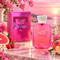RASASI Hawas Pink by Rasasi 100ml EDP — Pink perfume bottle and box displayed with fresh raspberries, sliced grapefruit, and delicate pink flowers against a sunset ocean backdrop.