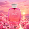 RASASI Hawas Pink by Rasasi 100ml EDP — Pink glass perfume bottle with white rope-like cap, surrounded by pink flower petals and water, with a sunset sky background.