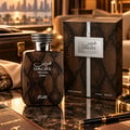 RASASI Hawas Private Terra by Rasasi 100ml EDP — Brown snakeskin textured perfume bottle and box with a silver snake-wrapped cap, set on a marble surface with a passport and pen.
