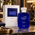 RASASI Hawas Sapphire FB Fragrances Edition by Rasasi 100ml EDP — Blue glass perfume bottle and white box with blue textured label, on a marble surface with cufflinks and a lamp in the background