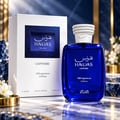 Rasasi Hawas Sapphire FB Fragrances Edition — Blue glass perfume bottle and white box with blue textured label, set on a marble surface with decorative elements.