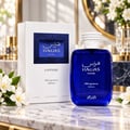 RASASI Hawas Sapphire FB Fragrances Edition by Rasasi 100ml EDP — Blue glass perfume bottle and white box with blue textured label, placed on a marble surface with white flowers.