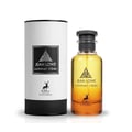 Maison Alhambra Jean Lowe Summer Vibes — A cylindrical white and black box stands next to a clear glass perfume bottle with yellow and orange gradient liquid, both featuring a black label with a deer silhouette and text. | Maison Alhambra Jean Lowe Summer Vibes — Kotak silinder putih dan hitam berdiri di sebelah botol
