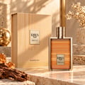 Khadlaj Karus Amber Gold EDP Unisex — A golden-hued perfume bottle and its matching box are displayed on a marble surface, with amber resin pieces and a piece of wood as props.