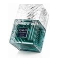 Lattafa Khamrah Waha Lattafa Perfumes 100ml EDP — A square, clear glass perfume bottle with a textured, faceted design and green liquid, tilted on a white background. | Lattafa Khamrah Waha Lattafa Perfumes 100ml EDP — Botol minyak wangi kaca jernih berbentuk segi empat dengan reka bentuk bertekstur dan faset serta